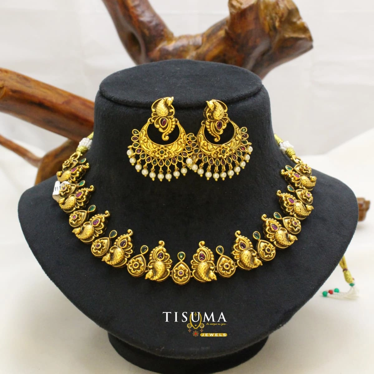 Antique gold-tone peacock necklace set with ruby-red and green stones and matching Chandbali earrings with pearl drops | Tisuma Jewels