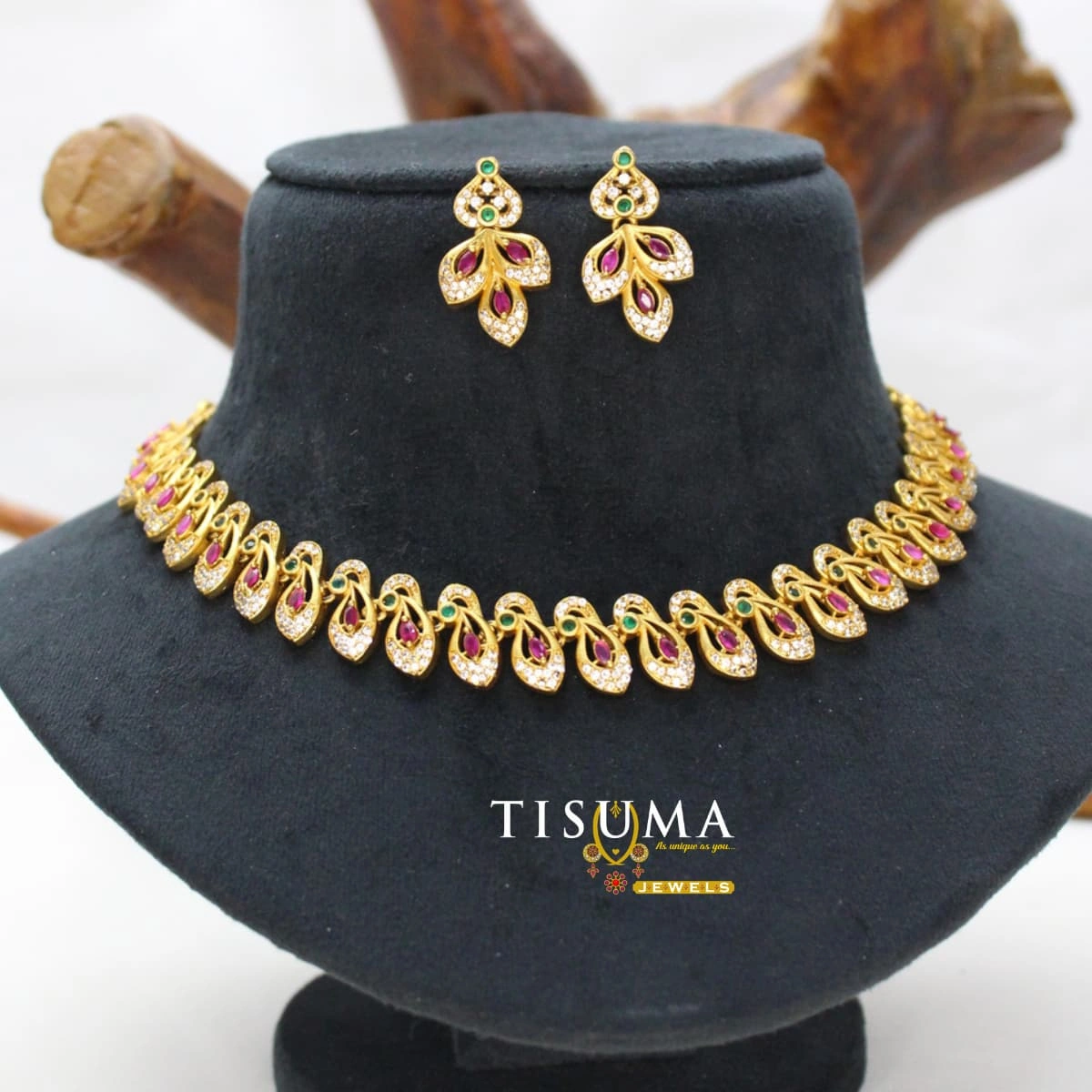 Gold-tone leaf design necklace set with ruby-pink, green and white AD-style stones and matching earrings | Tisuma Jewels