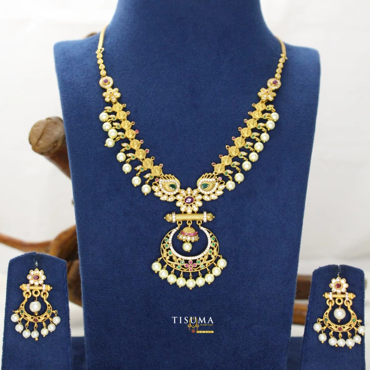 Traditional matte gold-tone peacock design necklace set with green and ruby stones, pearl drops and matching earrings | Tisuma Jewels