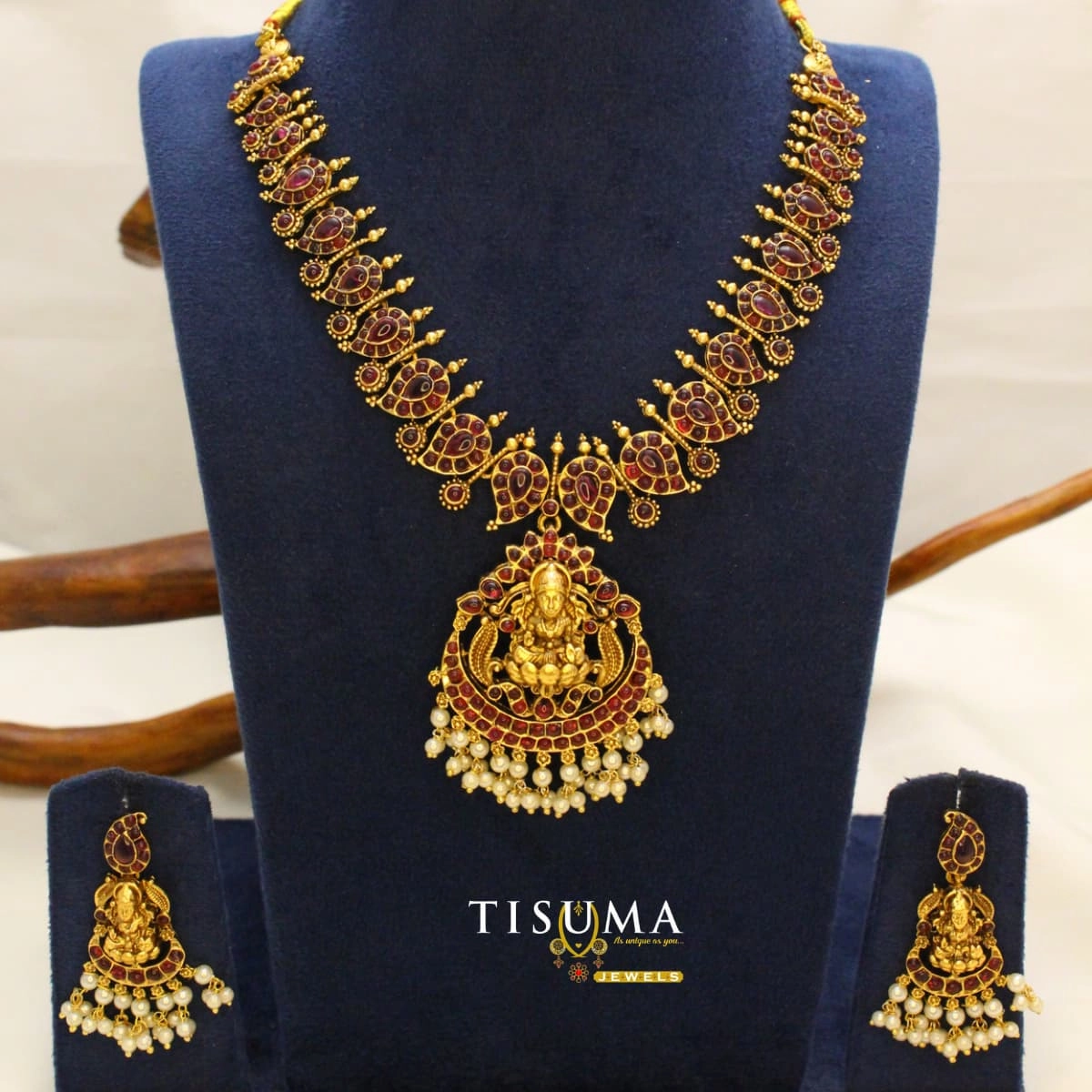 Antique gold Lakshmi temple necklace set with ruby-red stones and pearl drops, featuring matching Goddess Lakshmi earrings – Tisuma Jewels
