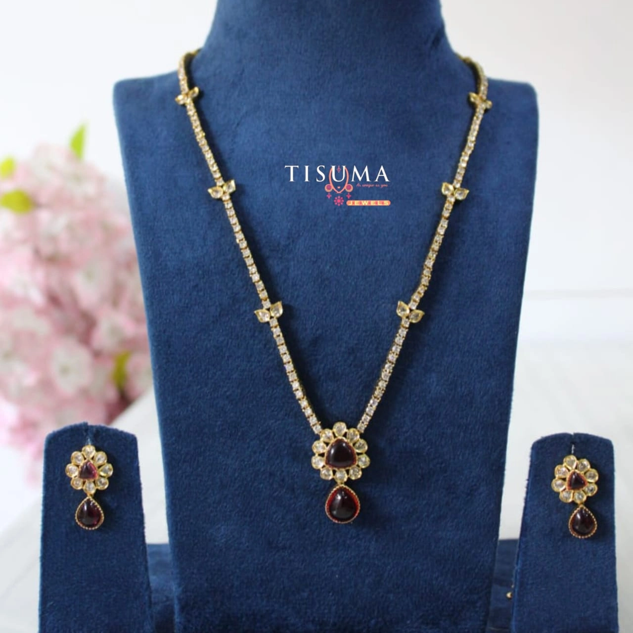 Gold-tone AD necklace with maroon triangular centre stone, teardrop pendant, and matching earrings