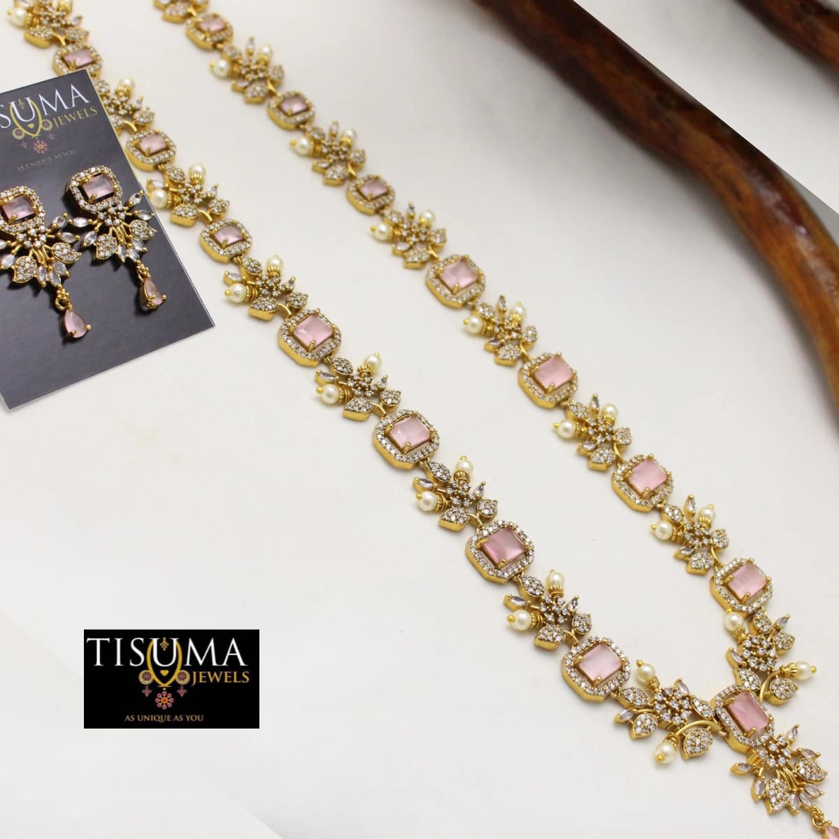 Tisuma Jewels gold haram necklace with pink rectangular stones, floral CZ detailing, pearl accents and matching earrings.