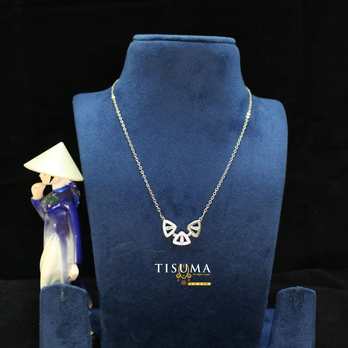 TISUMA silver-tone geometric American Diamond necklace with a sparkling fan-shaped pendant displayed on a blue velvet jewellery bust