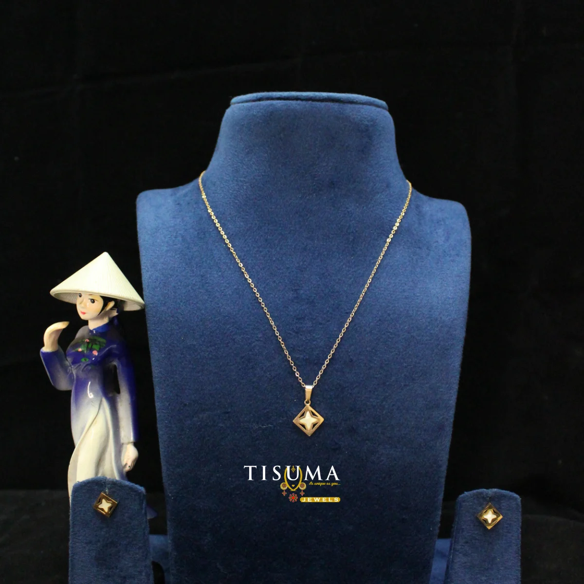 Gold-tone geometric pendant necklace with matching earrings by TISUMA JEWELS