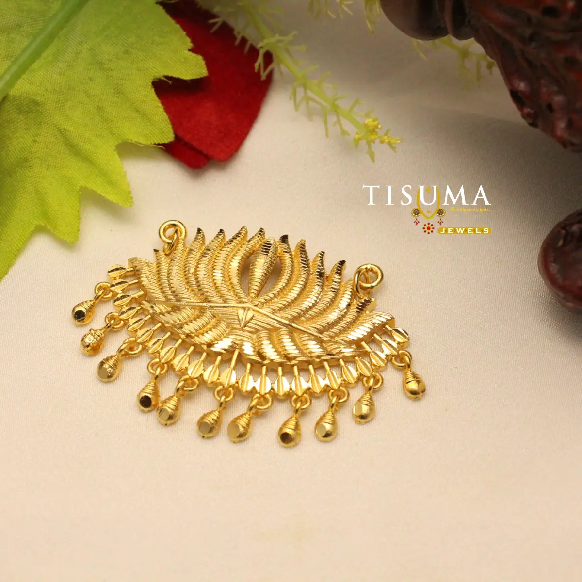 Gold-tone feather design forming dollar pendant with dangling details