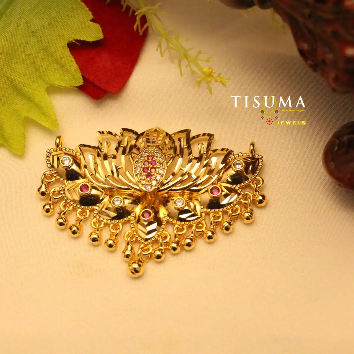 Gold-tone peacock fan forming dollar with multicolour stones and dangling beads
