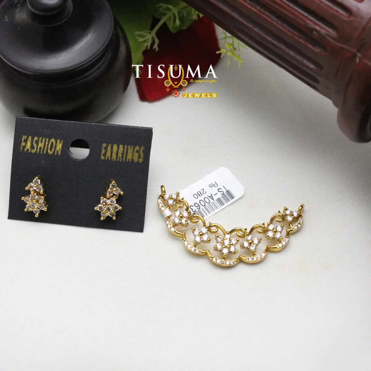 Tisuma Jewels gold-tone floral pendant with white stone detailing and matching floral earrings