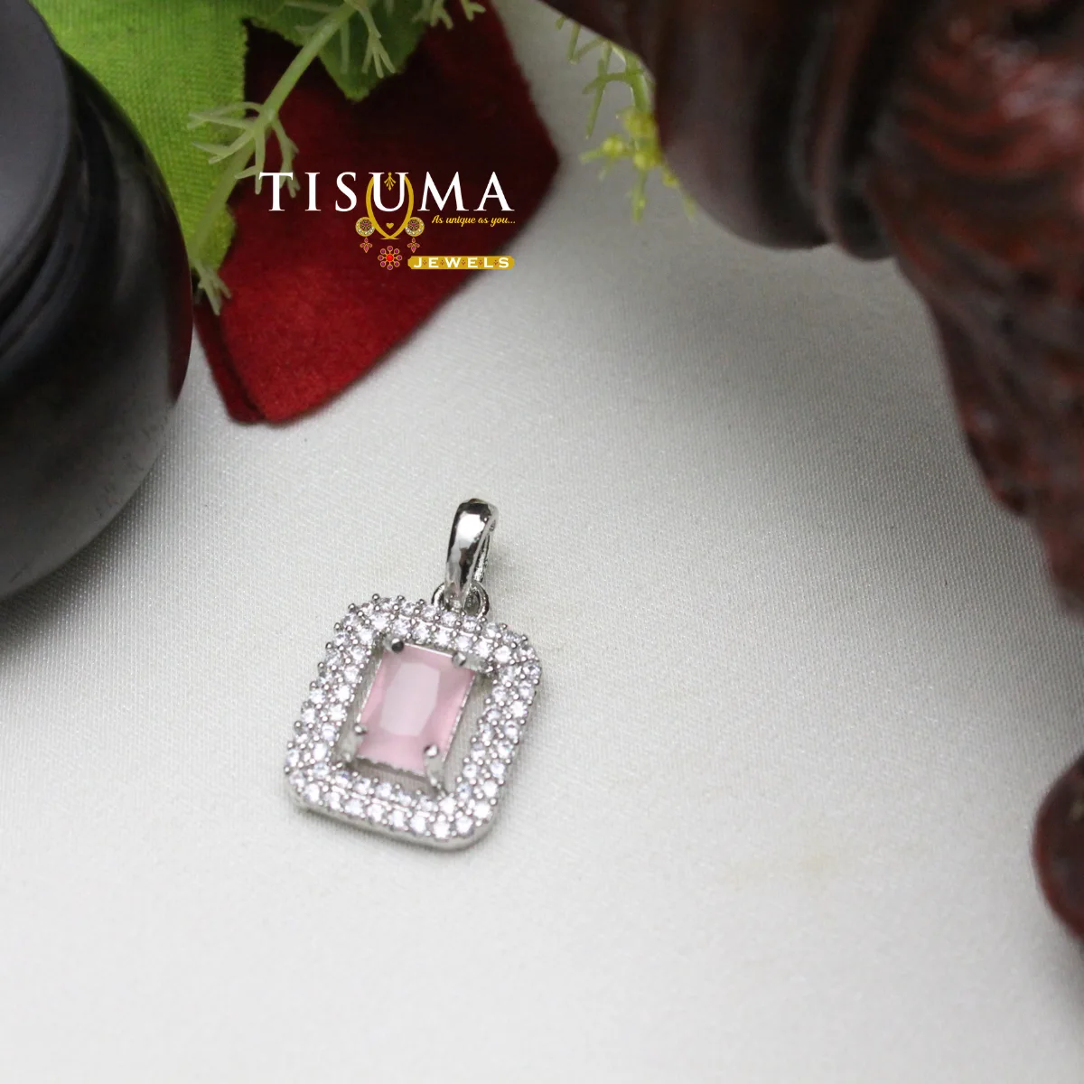 Silver-tone pendant with rectangular light pink centre stone and sparkling white stone border