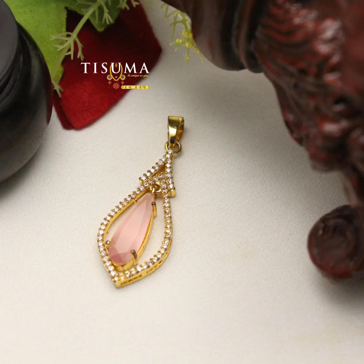 Pink teardrop stone pendant with gold-tone frame and sparkling crystal border
