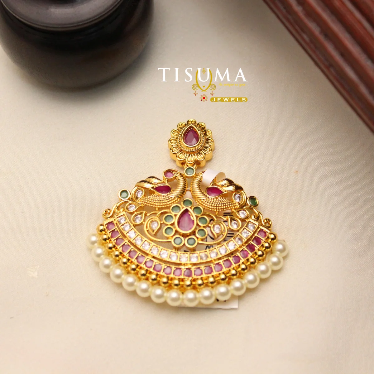 Gold polish peacock-inspired pendant with pink green stones and pearl drops