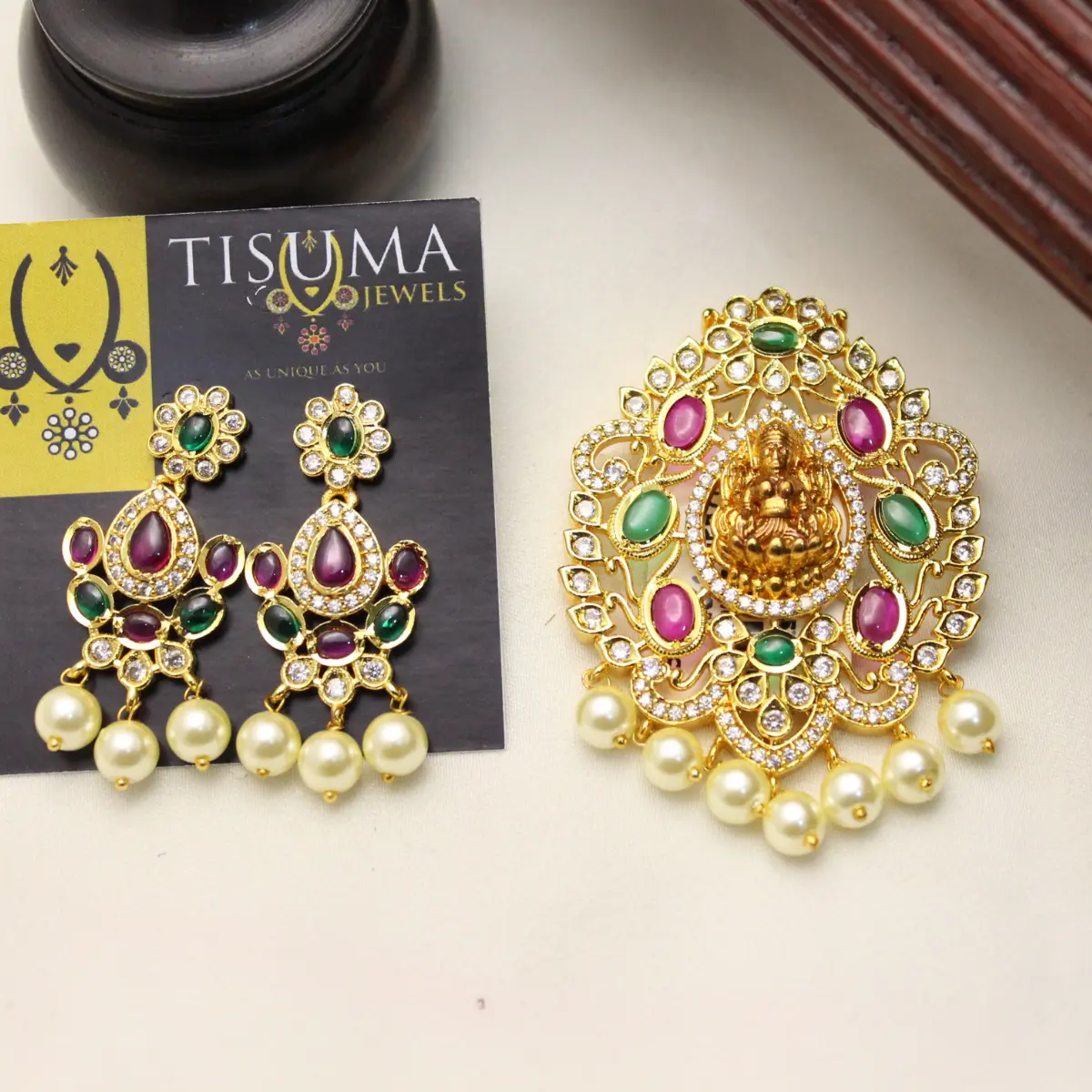 Gold polish Lakshmi pendant and matching earrings with pink green stones and pearl drops