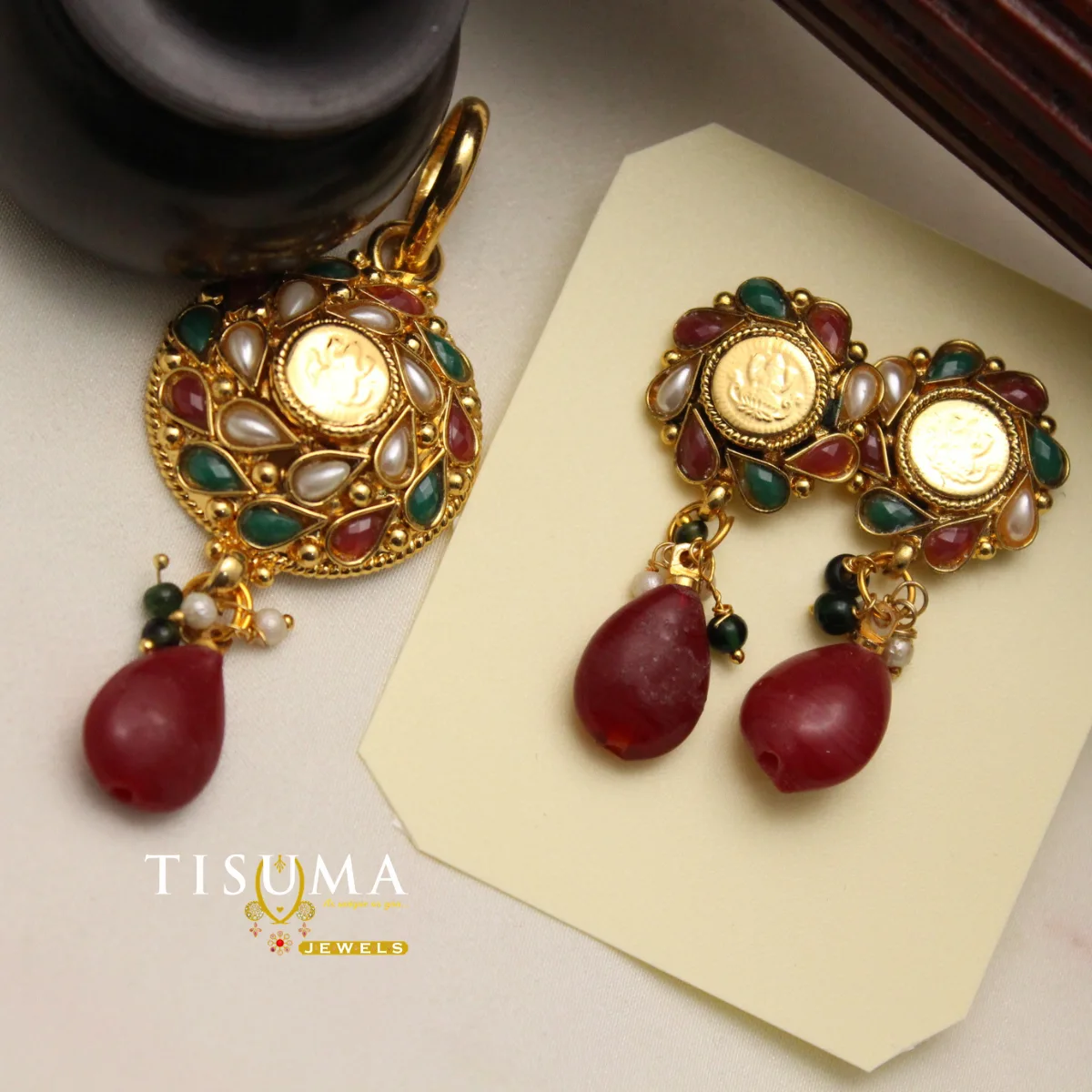 Antique gold temple pendant and matching earrings with red and green accents
