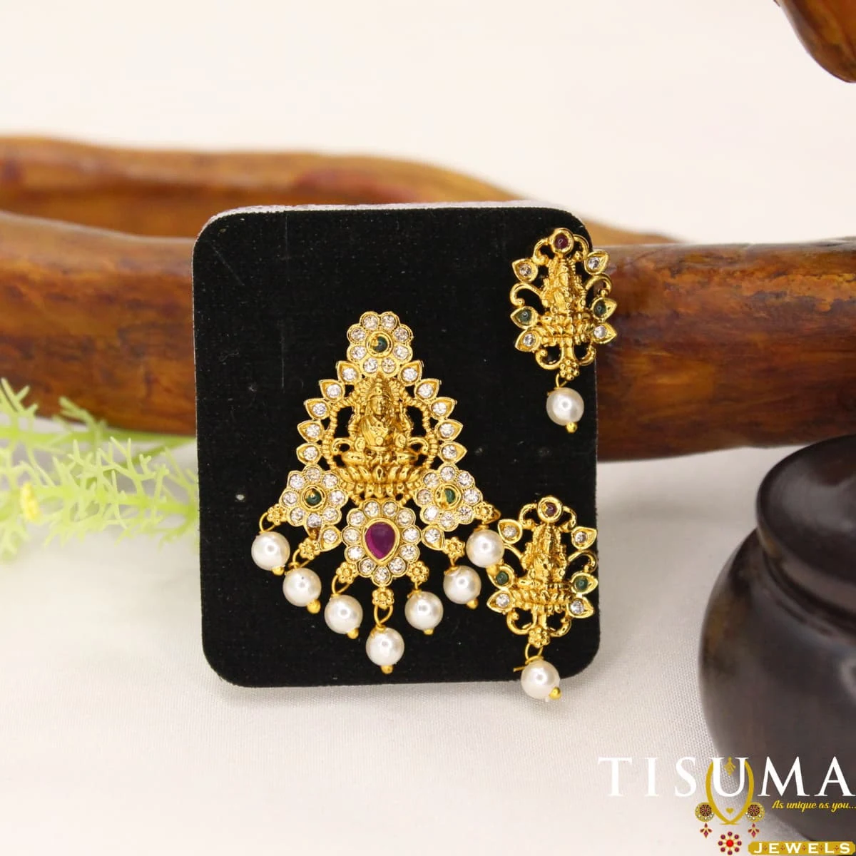Traditional gold-tone Lakshmi pendant set with ruby-colour and green stones, matching earrings, and pearl-like drops