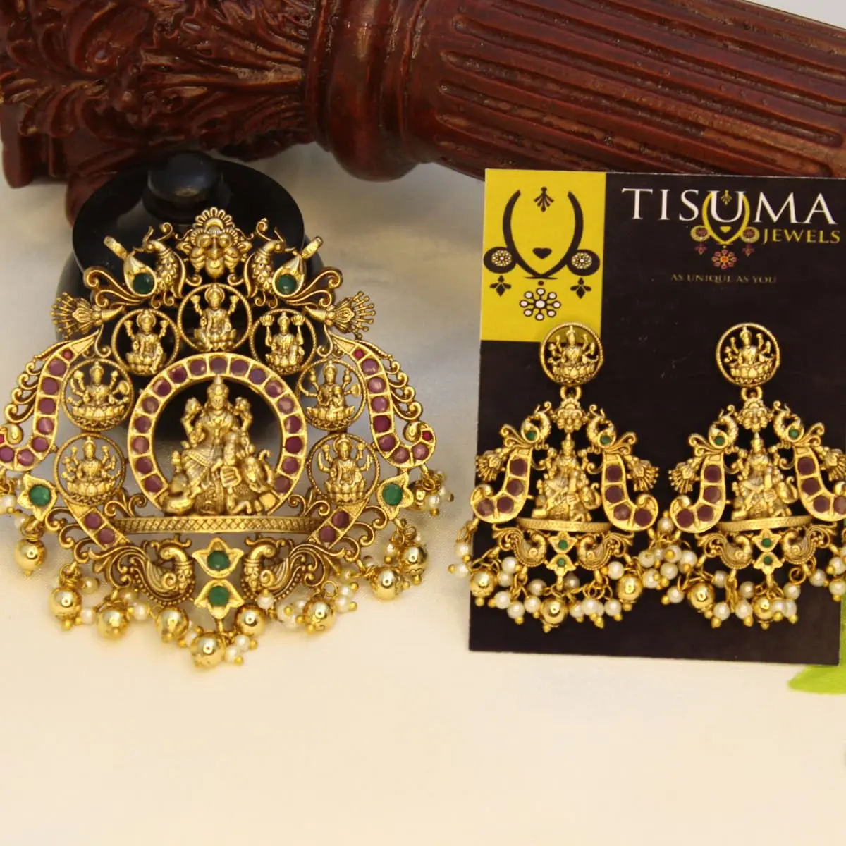 Traditional Lakshmi temple jewellery set with ruby-colour and green stones, goddess motifs, matching earrings, and pearl-like drops