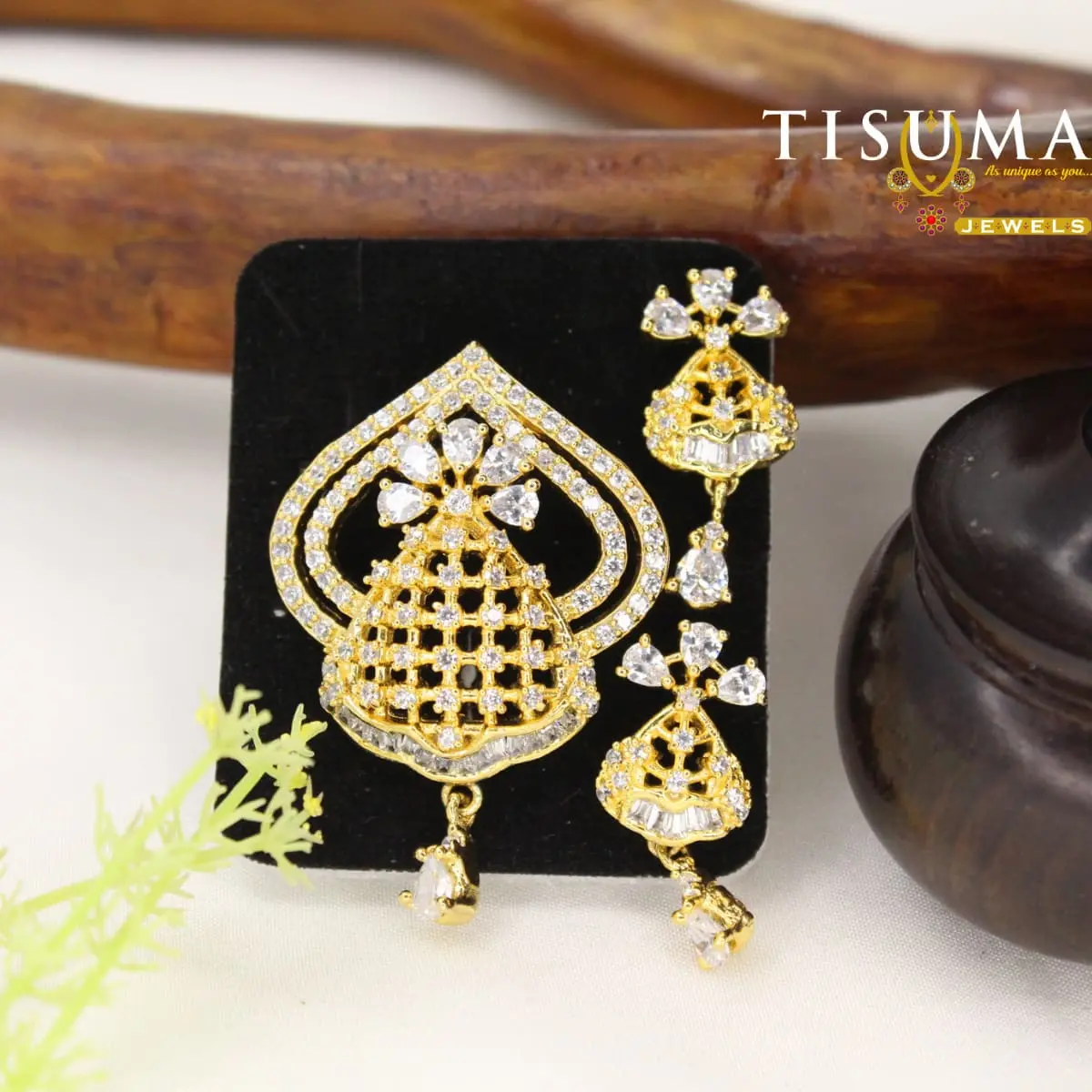 Gold-tone crystal pendant with matching drop earrings and geometric lattice design