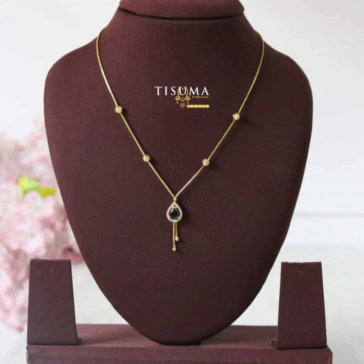 Tisuma Jewels gold-tone forming necklace with black teardrop pendant and decorative bead accents