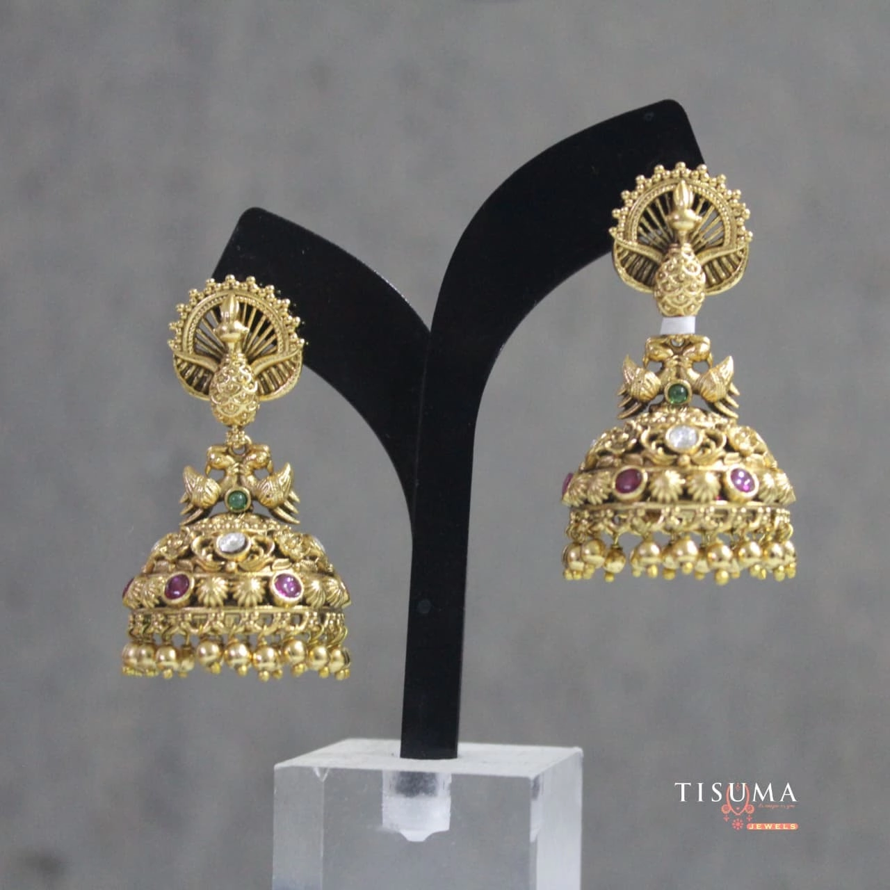 Traditional gold-tone peacock design jhumka earrings with colourful stones and hanging beads